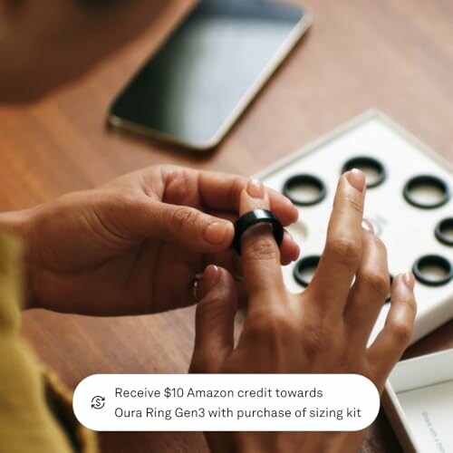 Person trying on Oura Ring with sizing kit on table.